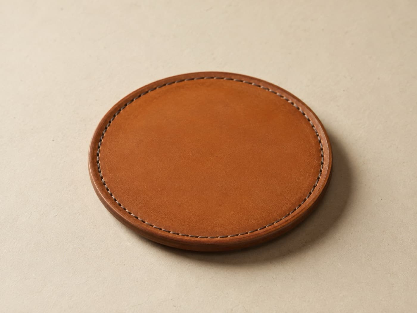 Bottle Coaster Ø 12 — A moulded disc with a low rim, for the bottle that sweats on a wooden table.